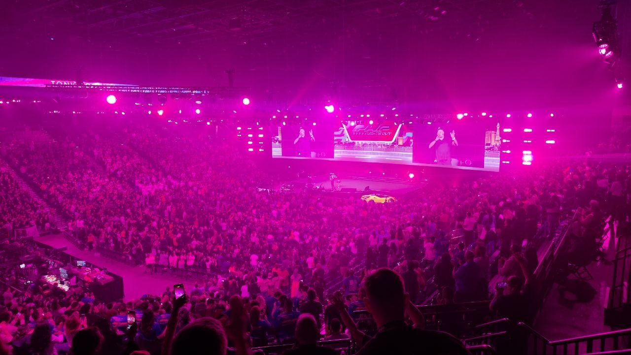 The PHP Lights Out 2026 main stage lit in magenta, with a full arena crowd