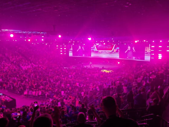 The PHP Lights Out 2026 main stage lit in magenta, with a full arena crowd