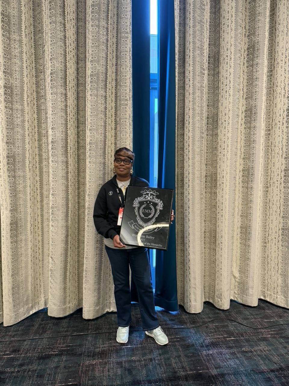 Winsome Bailey holding her Elite Money Movement plaque at PHP Lights Out 2026