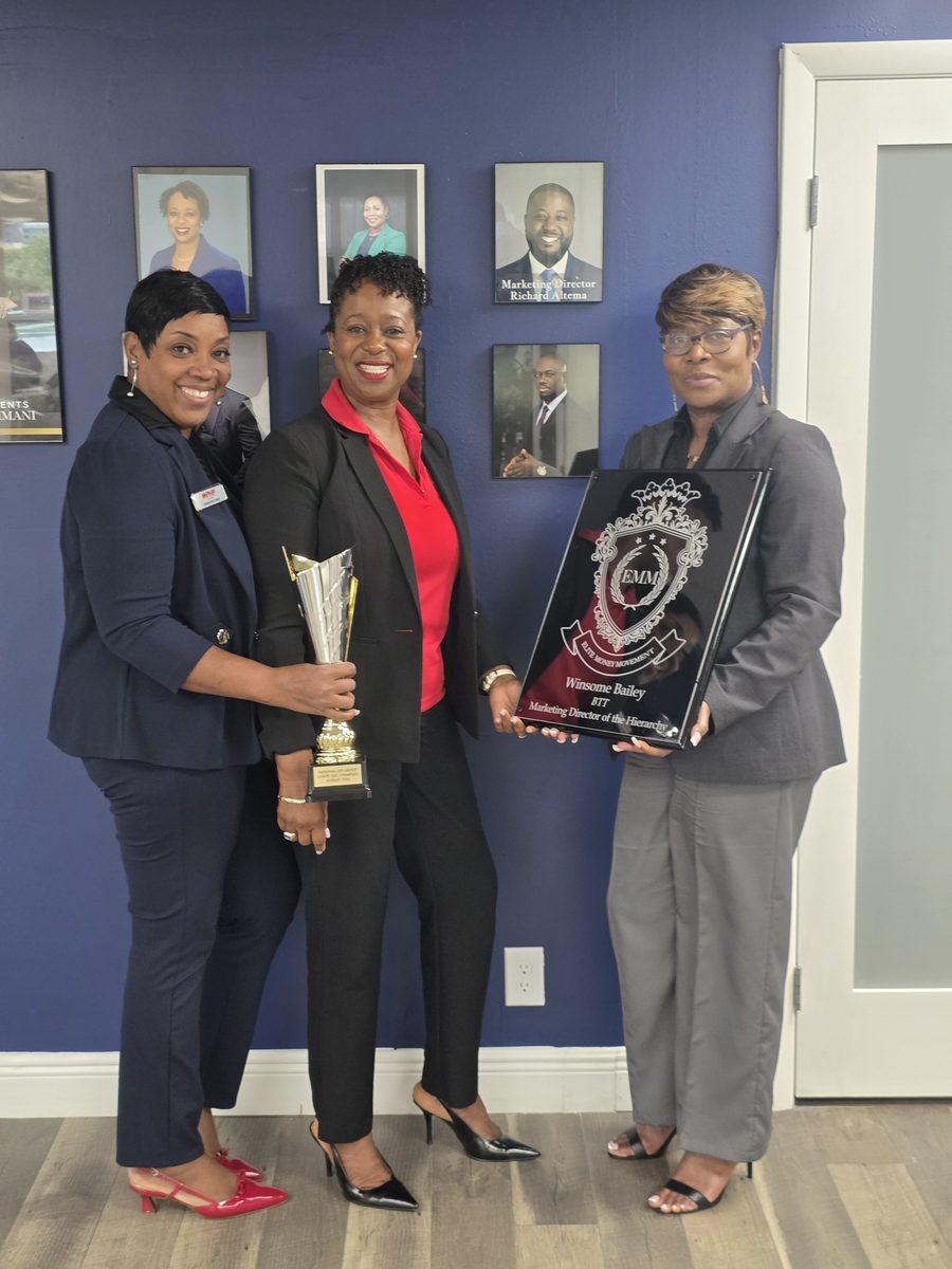 Three BTT leaders holding the Lights Out Champion trophy and the Elite Money Movement plaque