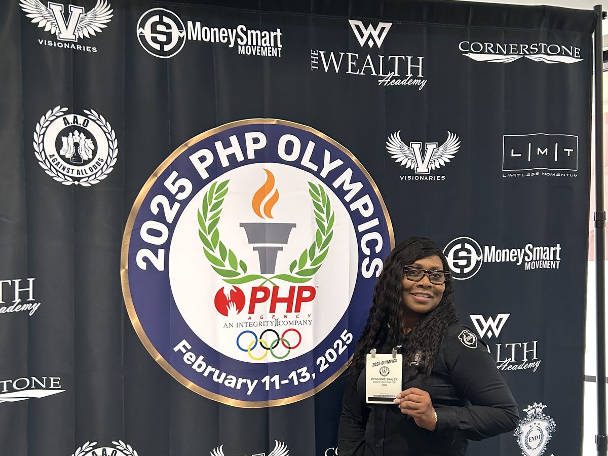 A BTT team member holding her event credential at the 2025 PHP Olympics