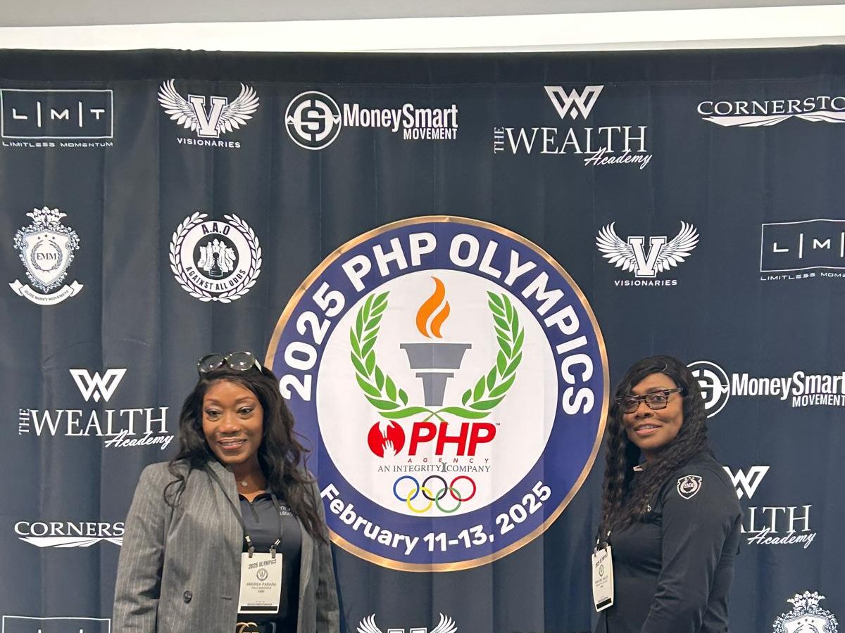 Two BTT team members at the 2025 PHP Olympics event backdrop