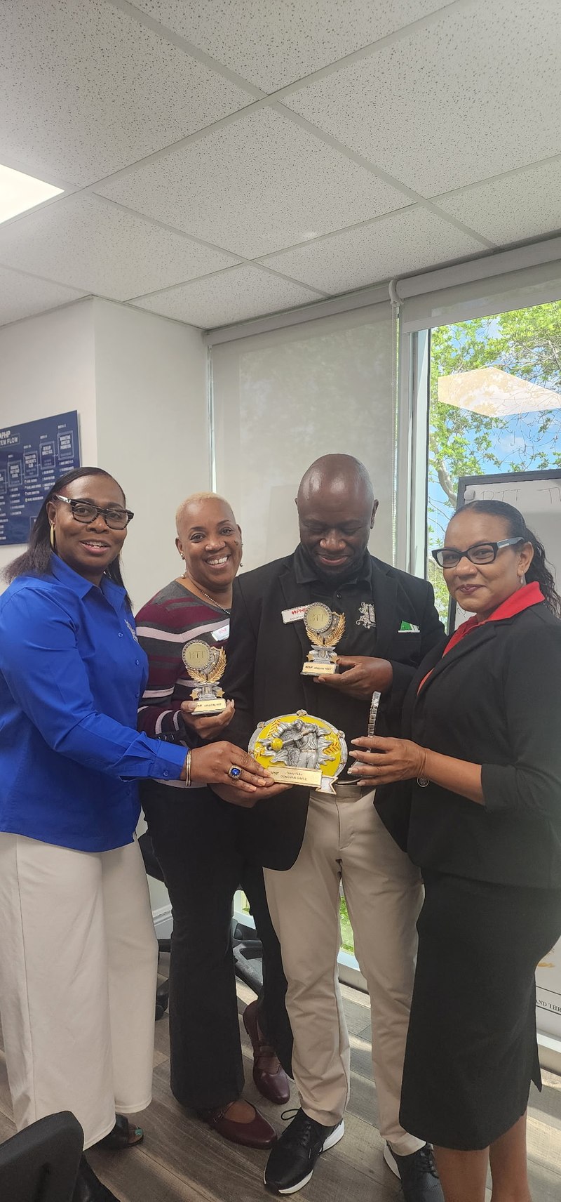 BTT team members receiving awards in the Pompano Beach office