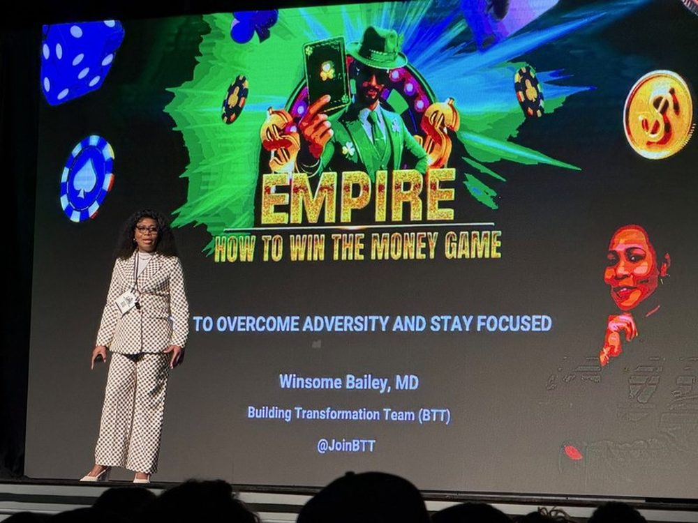 Winsome Bailey presenting on stage at a BTT team event