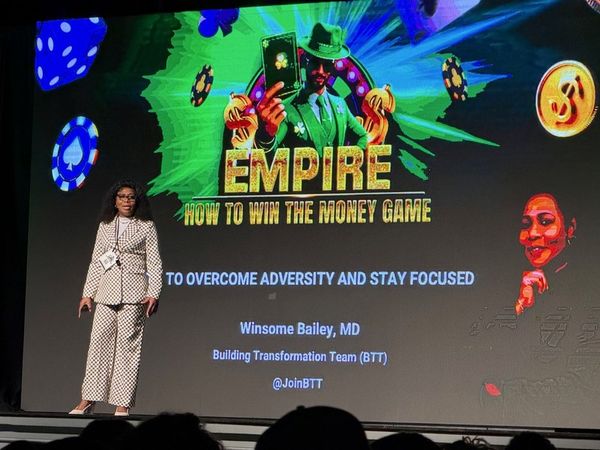 Winsome Bailey presenting on stage at a team event